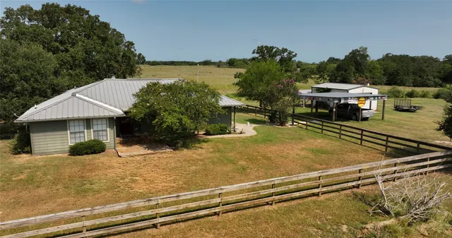 a front view of house with yard and outdoor seating