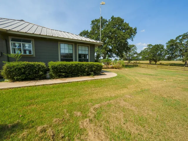 a view of a house with swimming pool and sitting area