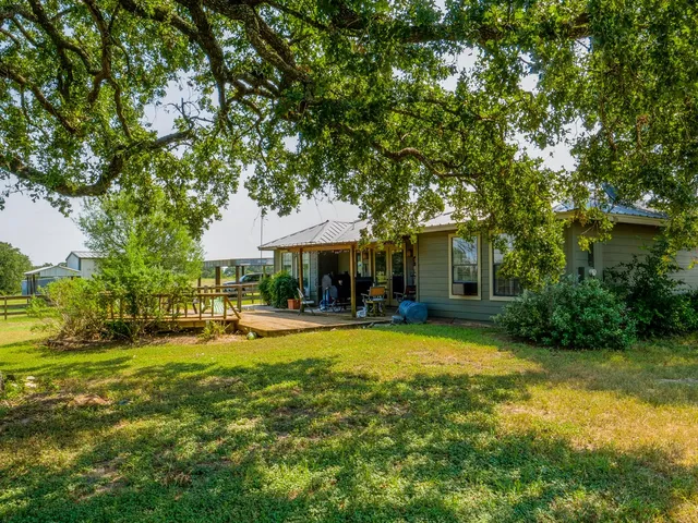 a living room with furniture rug and wooden floor