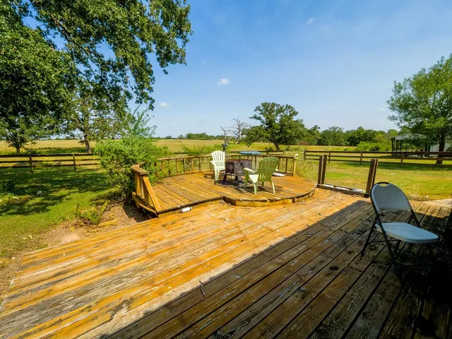 a dining room with furniture a rug and a chandelier