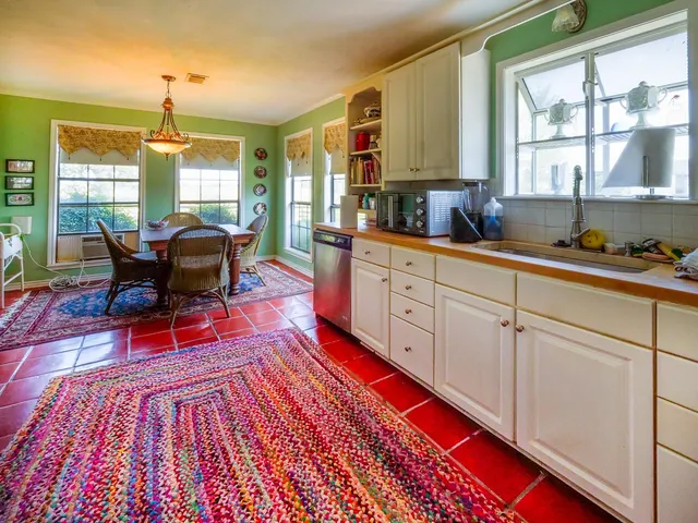 a kitchen with stainless steel appliances granite countertop a sink and cabinets