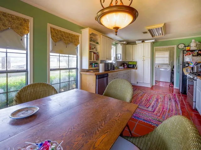 a kitchen with stainless steel appliances granite countertop a stove and a wooden floors