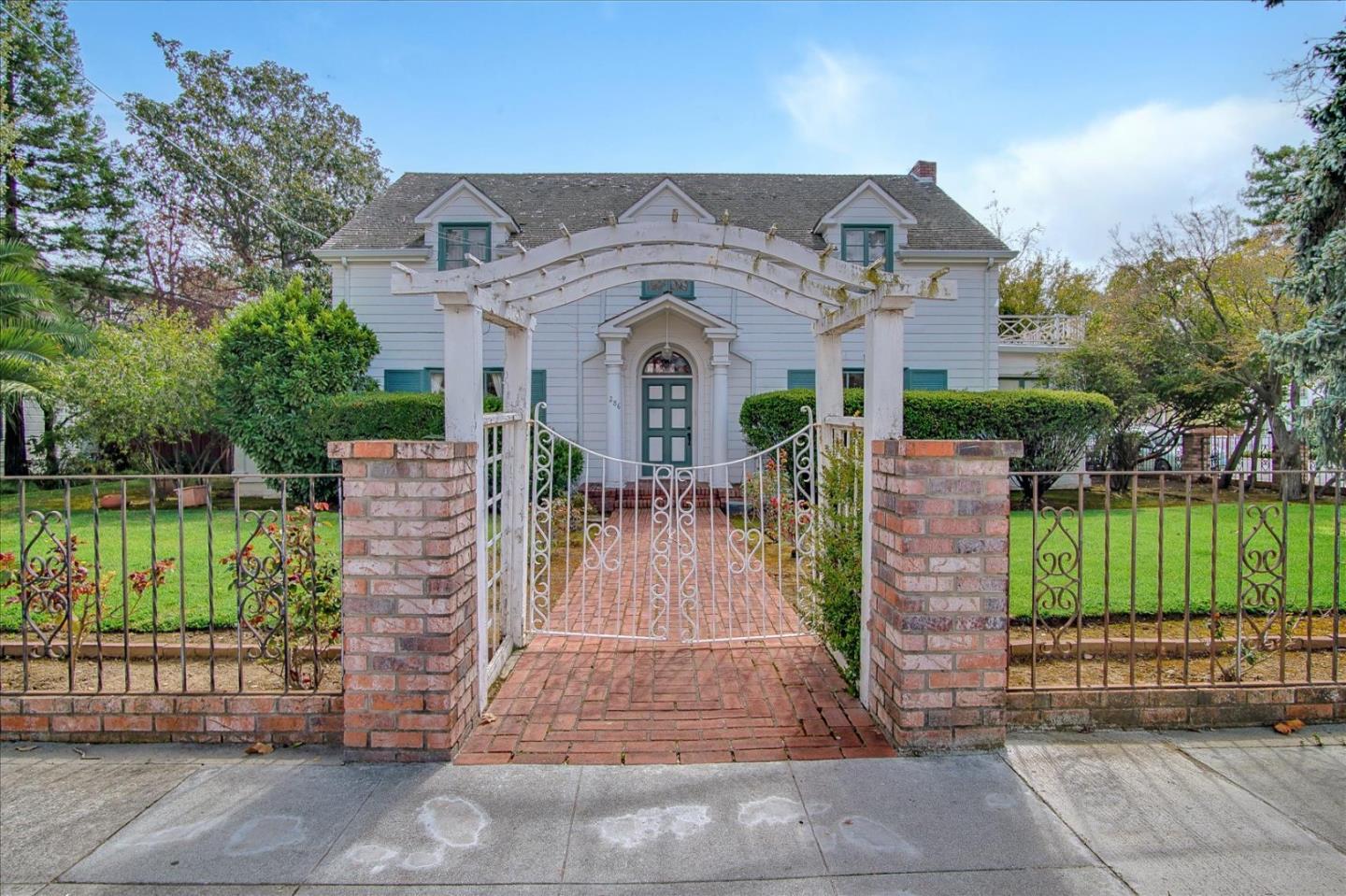 a front view of a house with a garden
