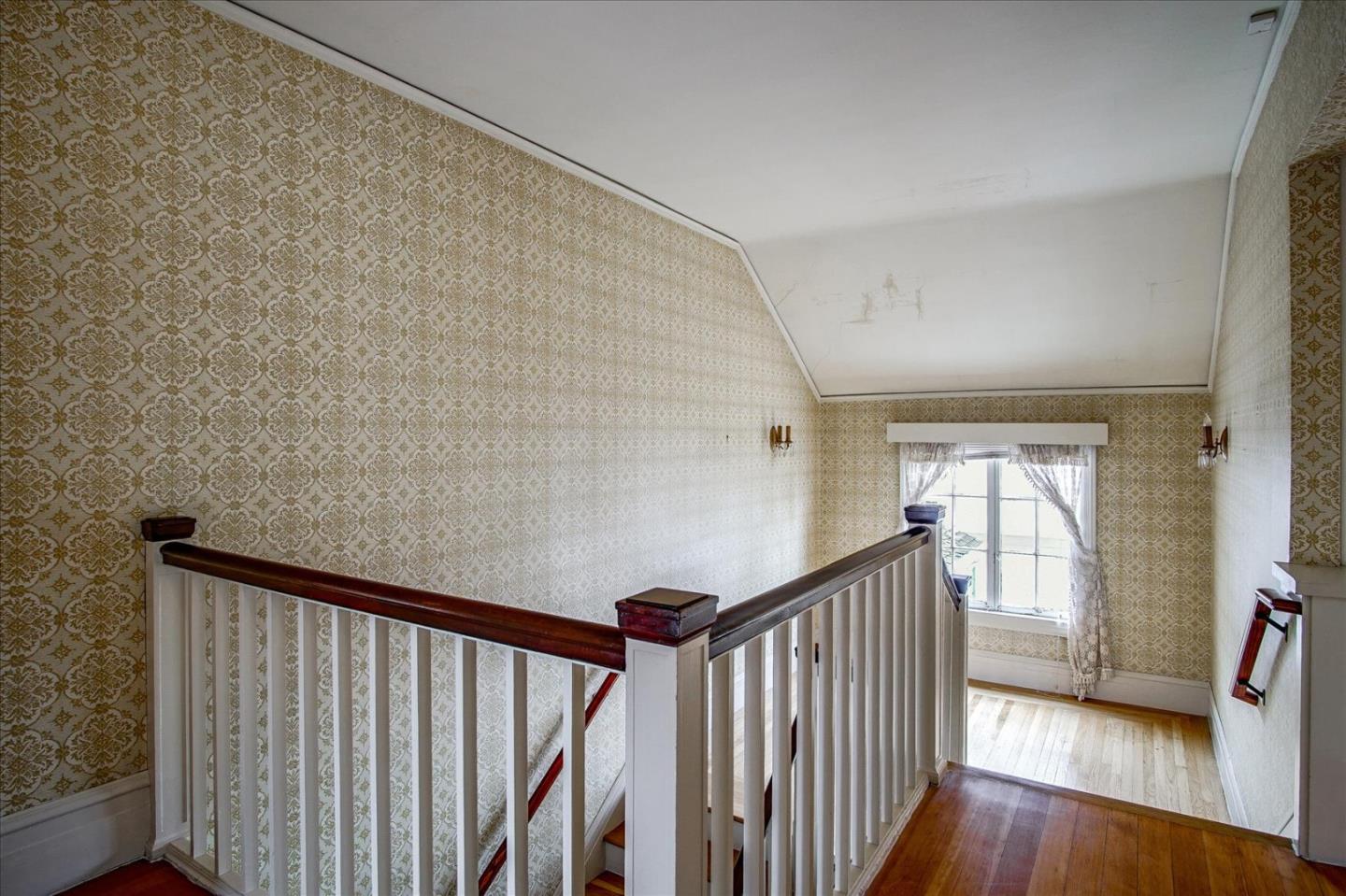 286 5th Street Gilroy, CA 95020 - Photo 17 of 47 a view of a hallway with wooden floor and staircase