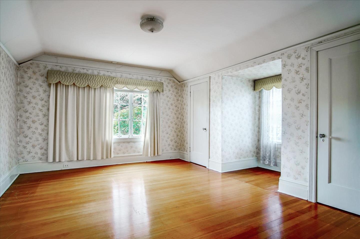 286 5th Street Gilroy, CA 95020 - Photo 24 of 47 a view of an empty room with wooden floor and a window