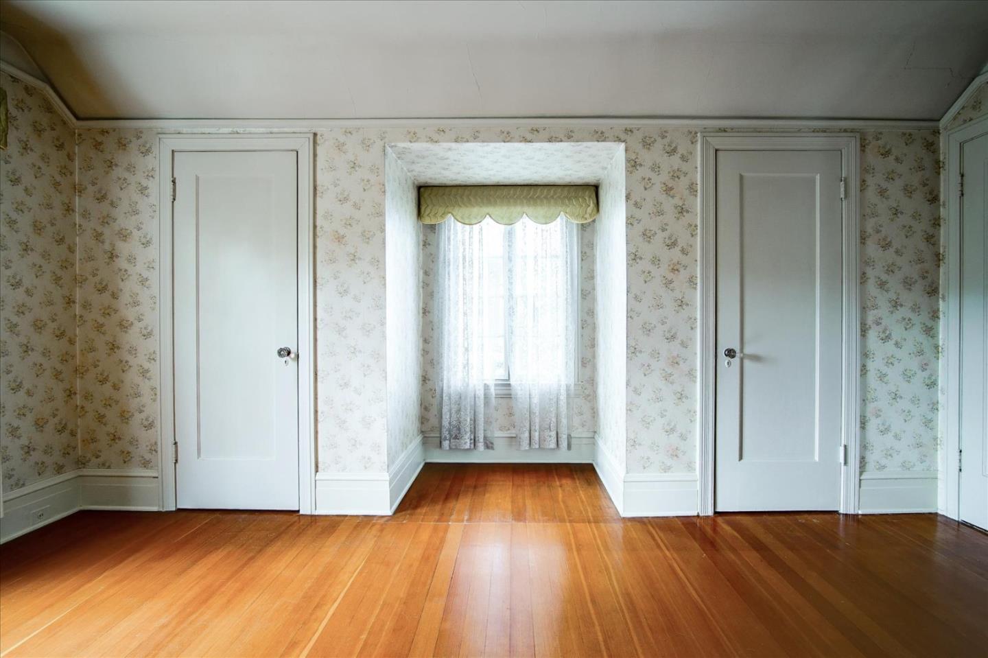 286 5th Street Gilroy, CA 95020 - Photo 26 of 47 a view of an empty room with wooden floor and a window