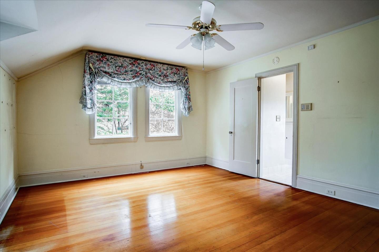 286 5th Street Gilroy, CA 95020 - Photo 28 of 47 an empty room with wooden floor chandelier fan and windows