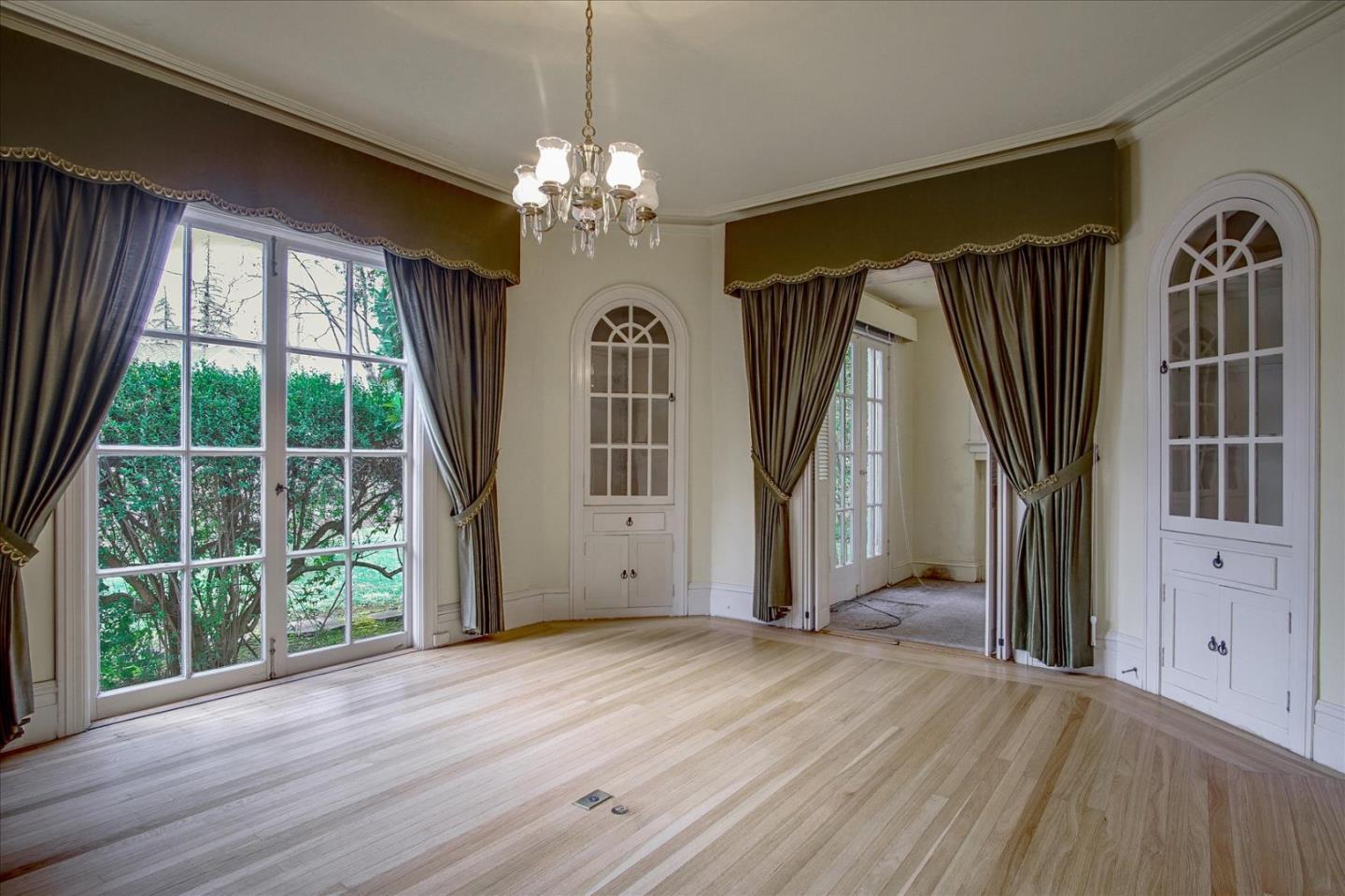 286 5th Street Gilroy, CA 95020 - Photo 9 of 47 a view of a bedroom with wooden floor fireplace and windows