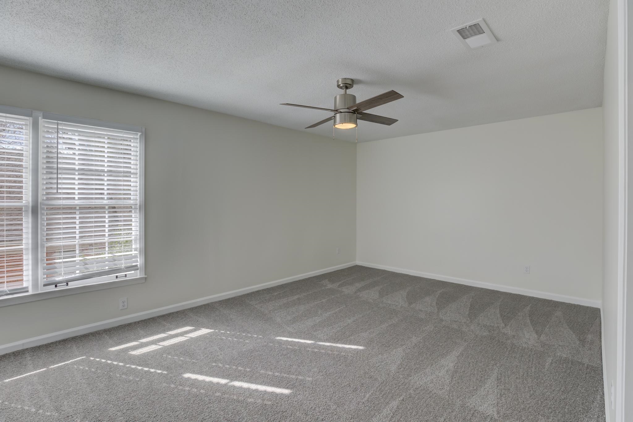 3997 Sawgrass Drive Memphis, TN 38125 - Photo 11 of 24 an empty room with a window and a ceiling fan