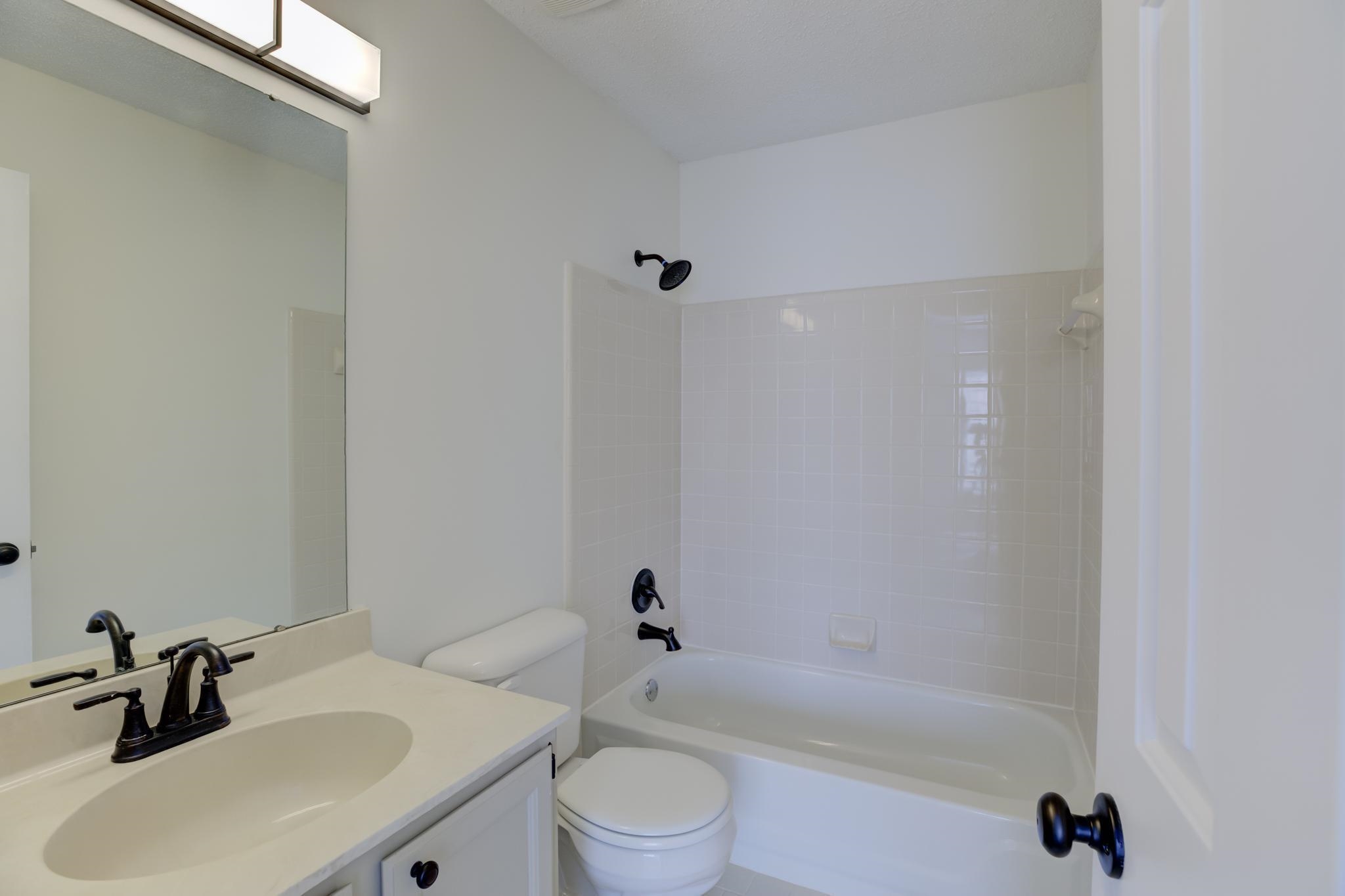 3997 Sawgrass Drive Memphis, TN 38125 - Photo 14 of 24 a bathroom with a sink a toilet and a bathtub
