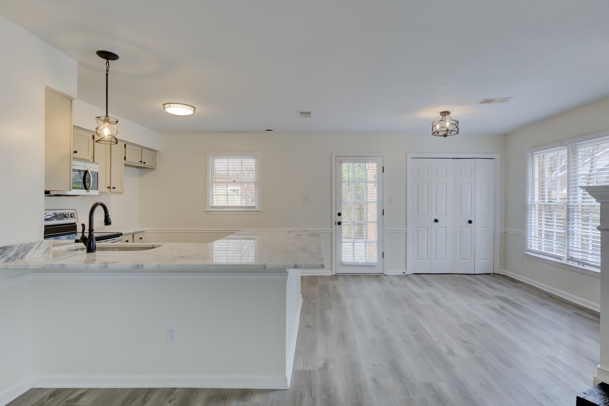 3997 Sawgrass Drive Memphis, TN 38125 - Photo 6 of 24 a view of a kitchen with granite countertop white cabinets and wooden floor