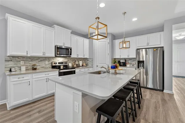 a kitchen with refrigerator cabinets and wooden floor