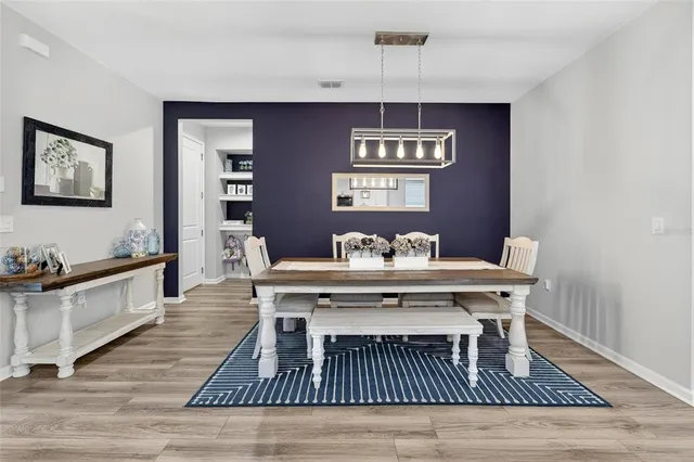 a living room with a couch and wooden floor