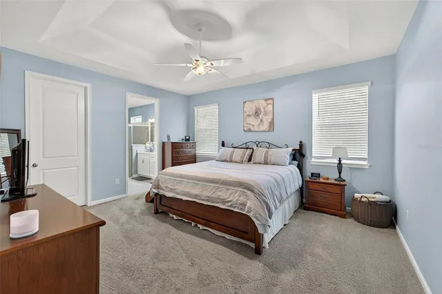 a spacious bedroom with a bed and a table in it