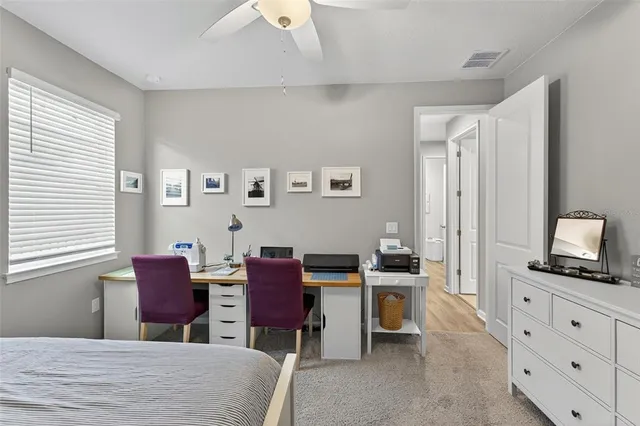 a bedroom with furniture and a flat screen tv