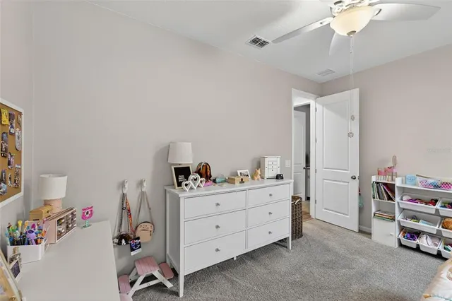 a room with a baby bed baby crib and a dresser