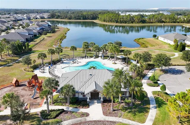 an aerial view of a house with outdoor space and lake view