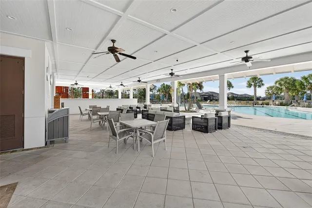 a room with lots of table chair and view kitchen