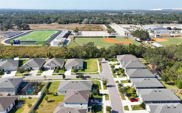 an aerial view of residential houses with outdoor space