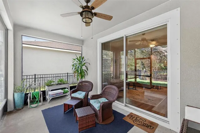 a view of a livingroom with furniture and floor to ceiling window