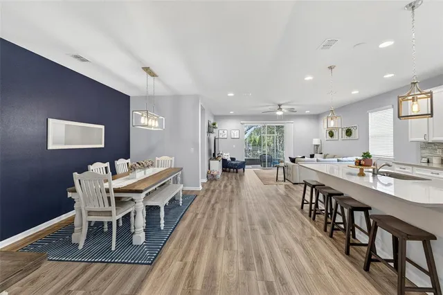 a dining room with furniture a rug and wooden floor