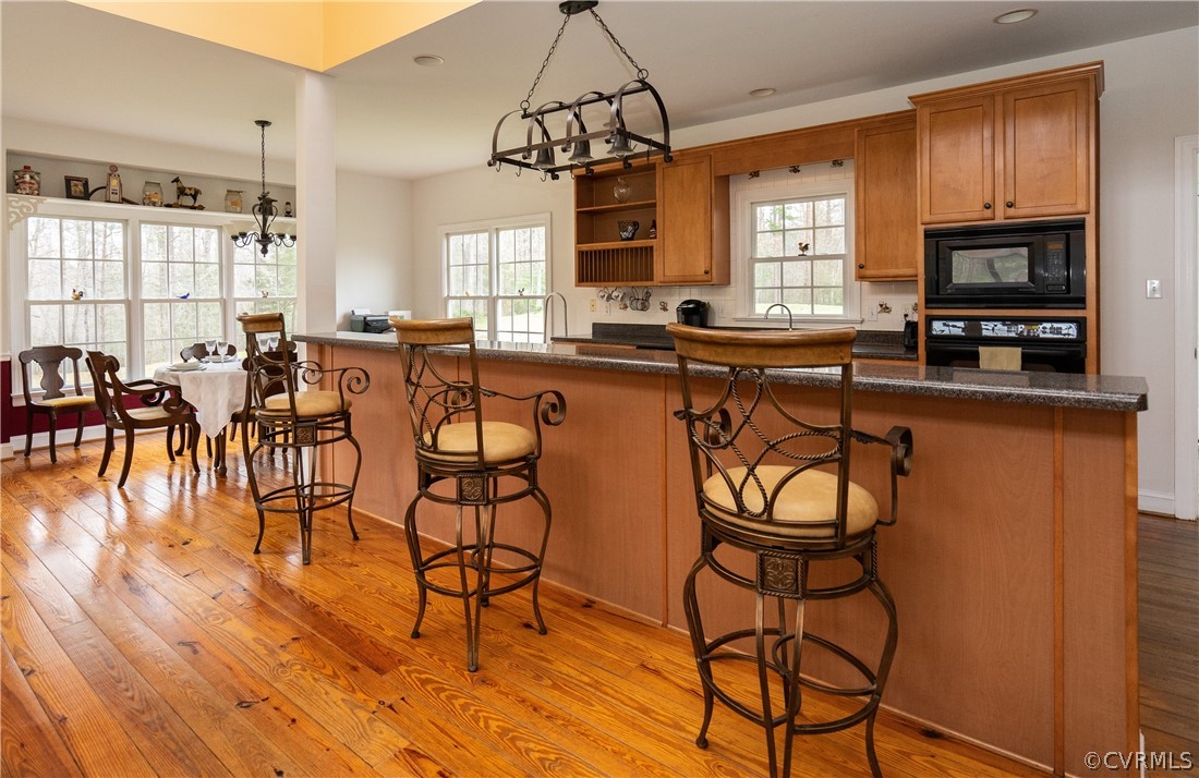 16372 Ancient Acres Road Beaverdam, VA 23015 - Photo 8 of 44 a very nice looking kitchen with granite countertop wooden floors and white cabinets