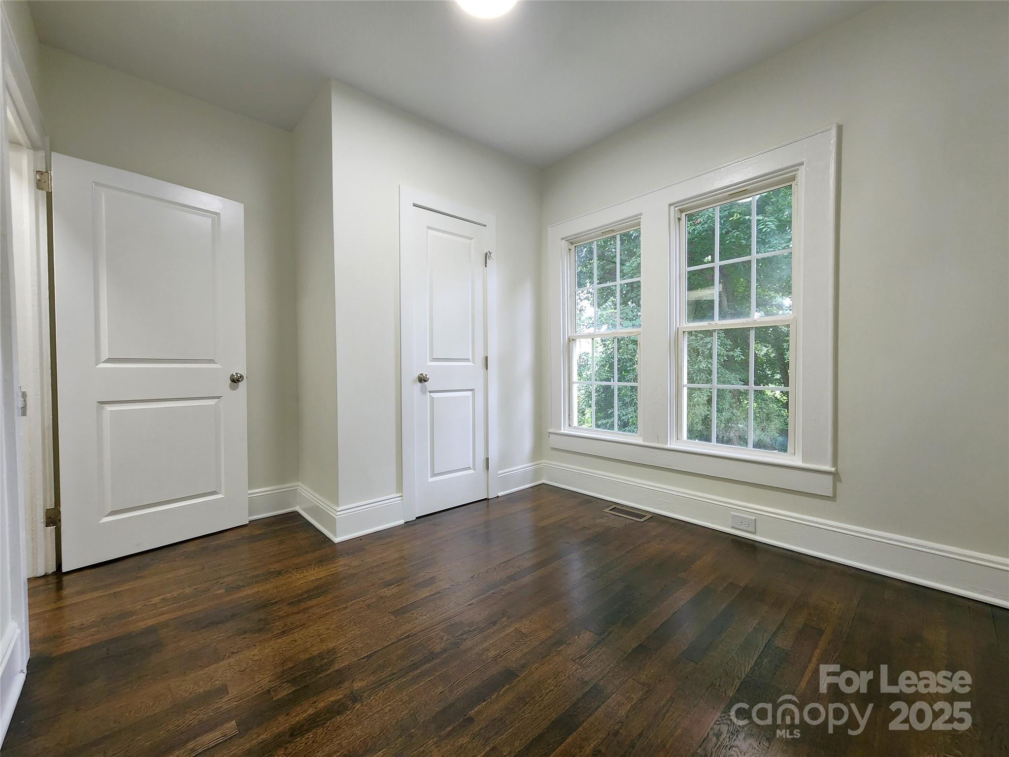 179 Duval Street Northwest Concord, NC 28025 - Photo 13 of 18 an empty room with wooden floor and windows