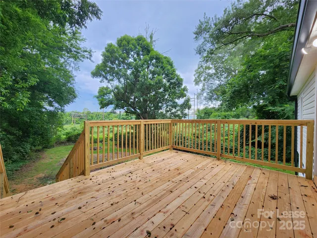 a view of balcony with wooden floor and fence