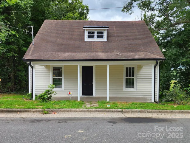 a front view of a house with a yard and a garage