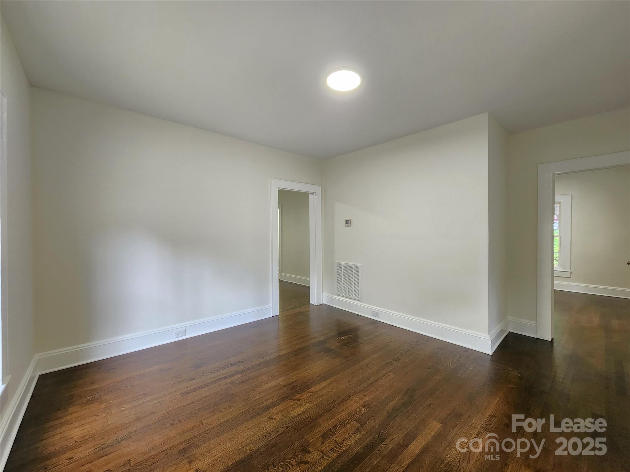 179 Duval Street Northwest Concord, NC 28025 - Photo 6 of 18 a view of an empty room with wooden floor
