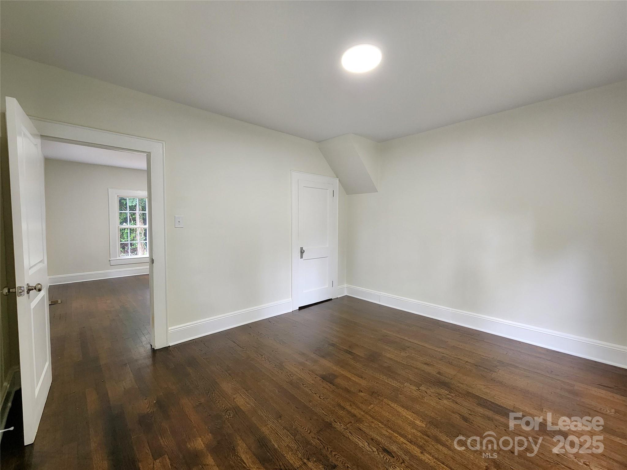 179 Duval Street Northwest Concord, NC 28025 - Photo 7 of 18 a view of an empty room and wooden floor