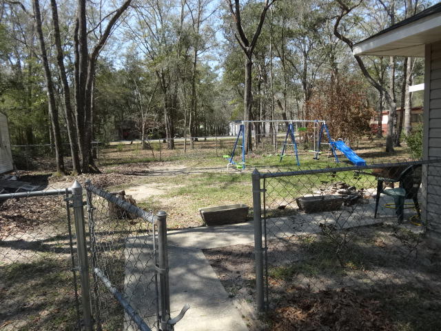110 Redfish Road Freeport, FL 32439 - Photo 12 of 13 fenced back yard and screened porch