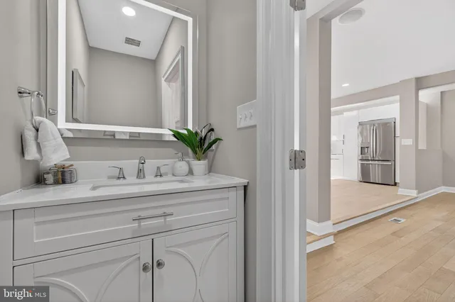a view of bathroom with a sink and mirror
