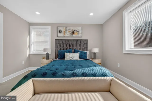 a bedroom with a large bed and a window