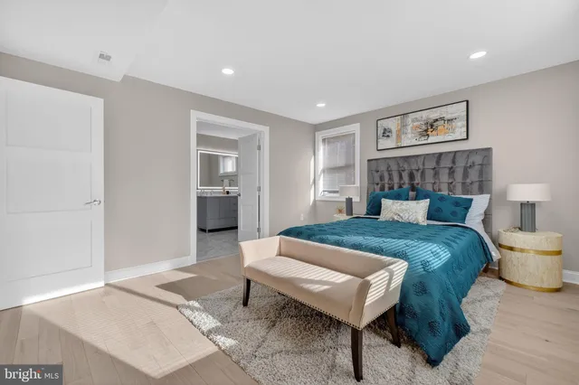 a spacious bedroom with a bed and a table in it