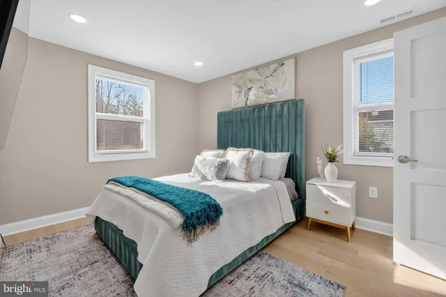 a bedroom with a large bed and a window