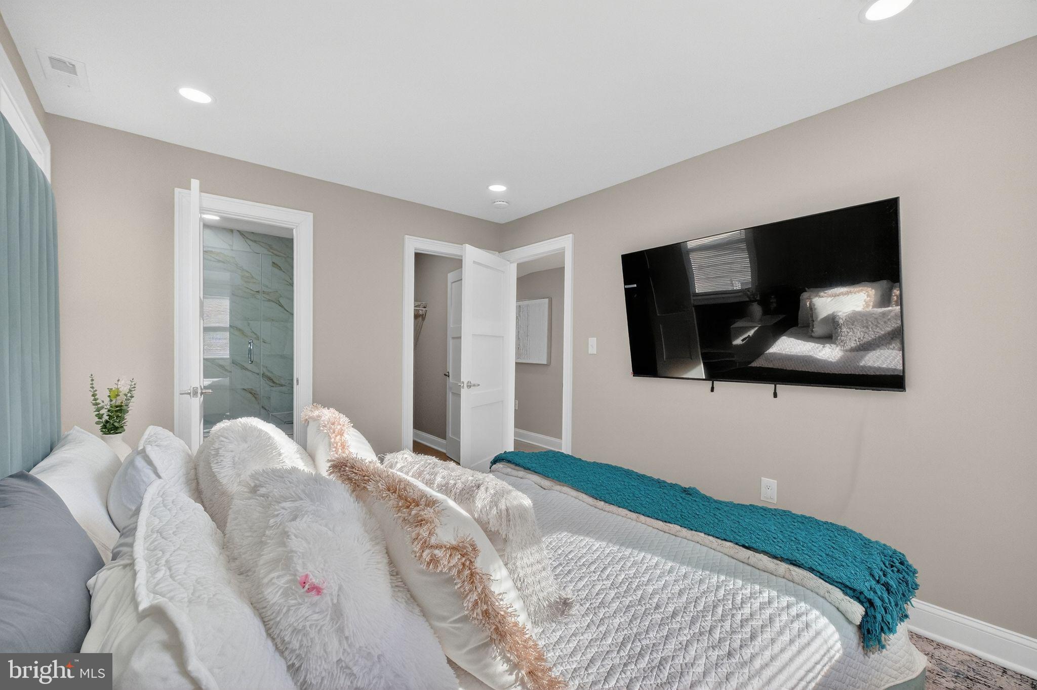 3151 Newton Street Northeast Washington, DC 20018 - Photo 20 of 49 a bedroom with a large bed and a flat screen tv