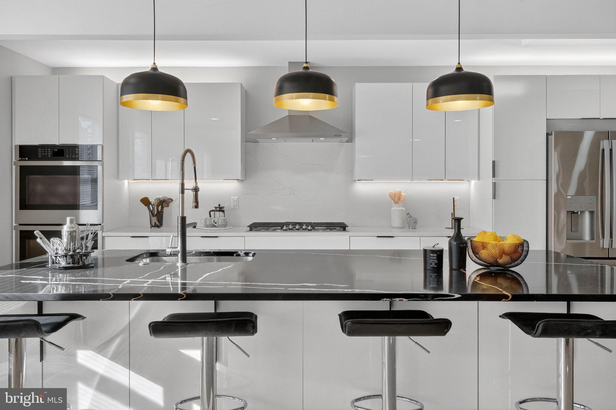 3151 Newton Street Northeast Washington, DC 20018 - Photo 2 of 49 a kitchen with stainless steel appliances granite countertop a stove a sink and a chandelier