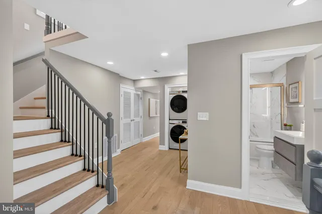 a view of a kitchen with wooden floor and cabinets