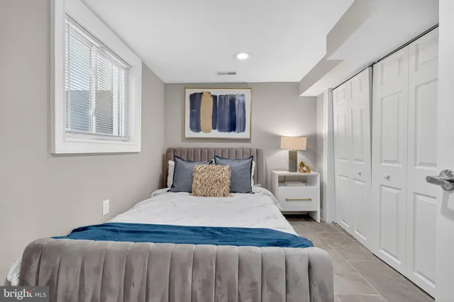 a bedroom with a large bed and a window