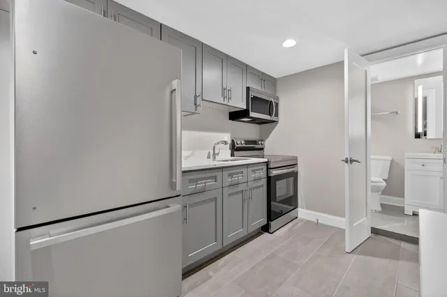 a kitchen with stainless steel appliances a refrigerator stove and sink