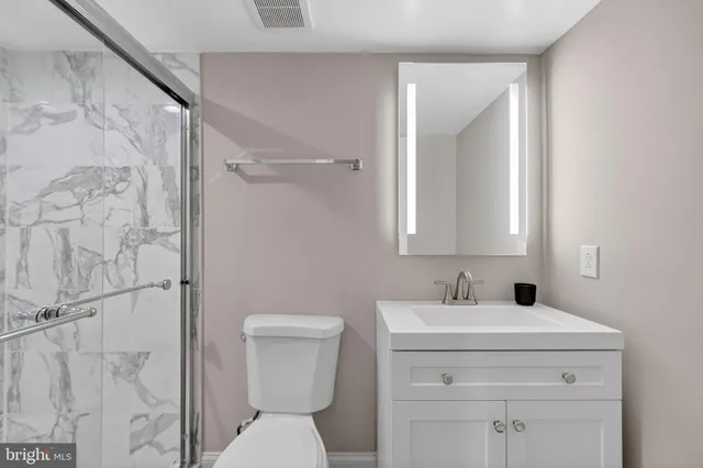 a bathroom with a toilet sink and shower