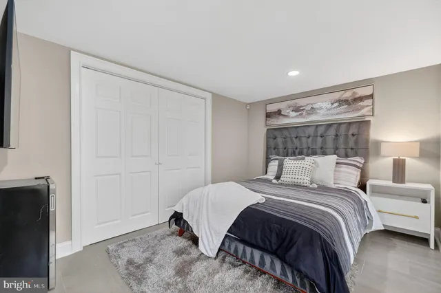 a bedroom with a bed and a night stand