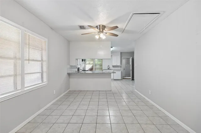 a view of kitchen with windows and ceiling fan