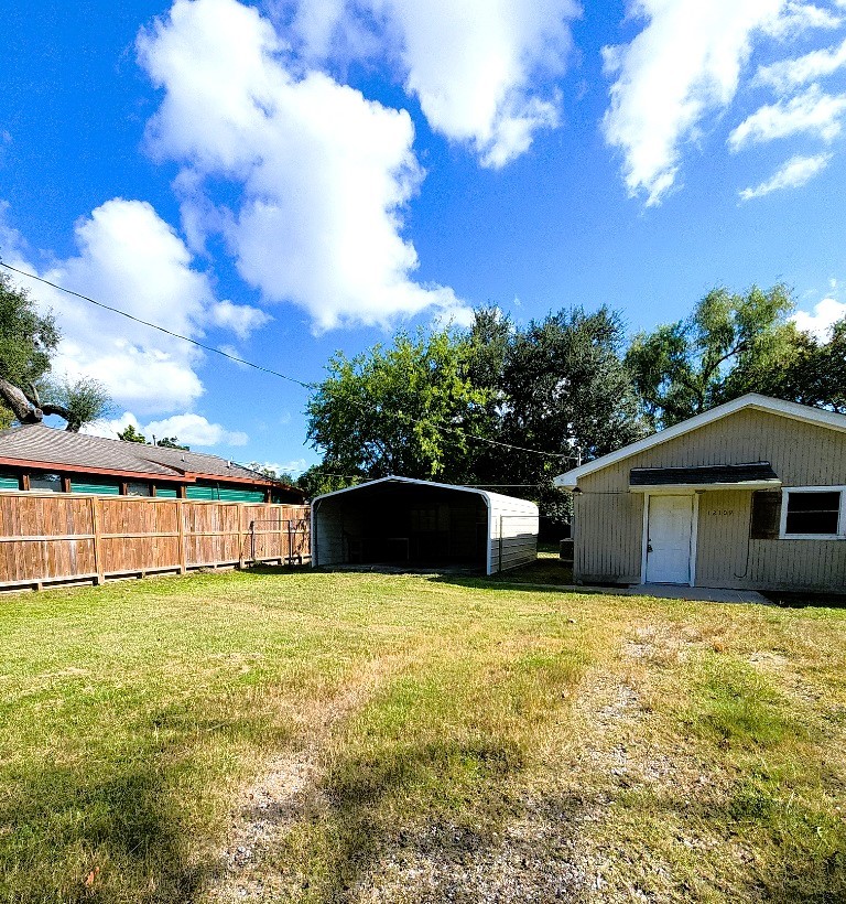 12109 22nd Street Santa Fe, TX 77510 - Photo 13 of 14 a view of a house with yard and roof