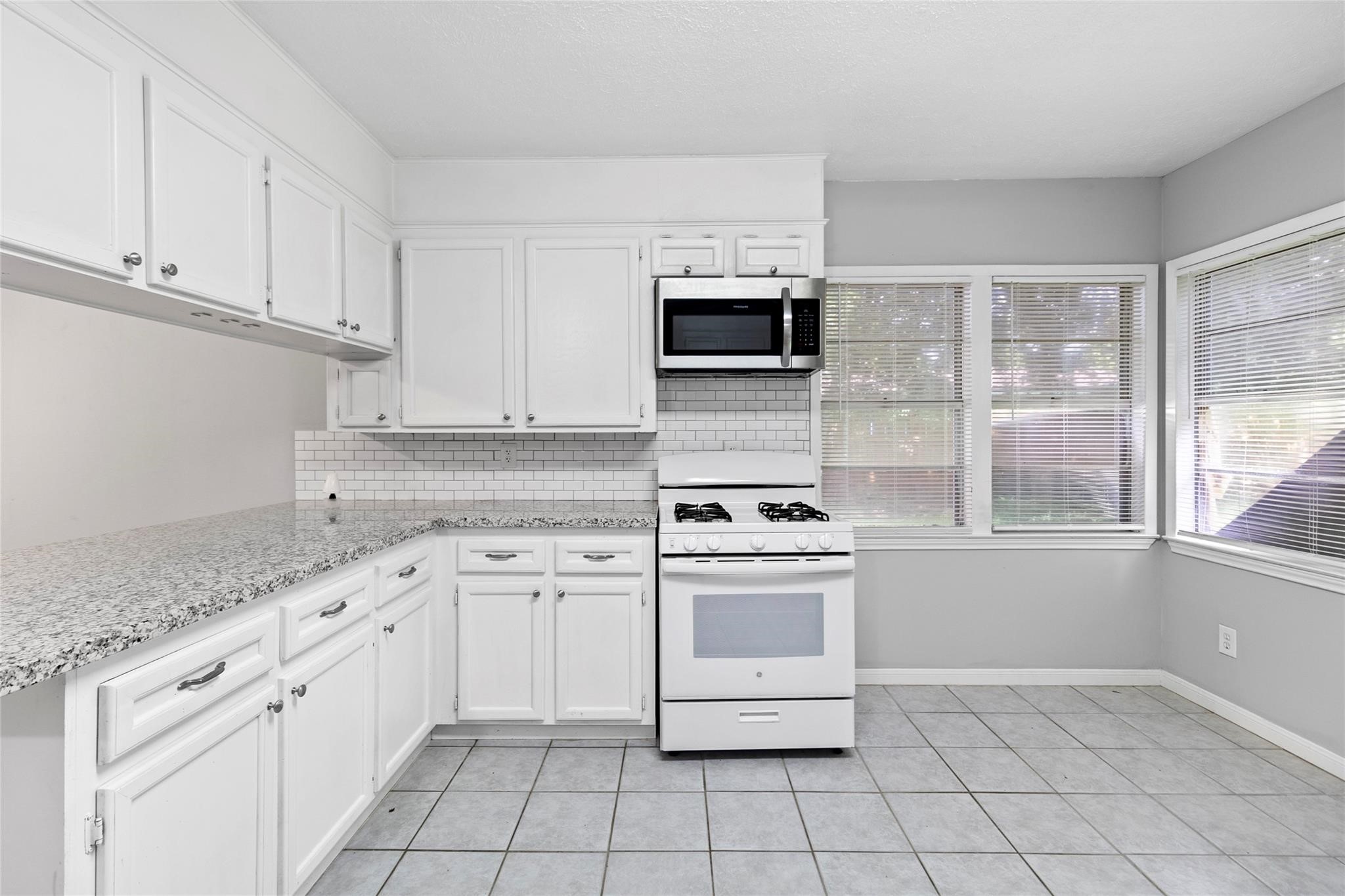 12109 22nd Street Santa Fe, TX 77510 - Photo 3 of 14 a kitchen with white cabinets appliances and sink