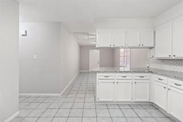 a kitchen with white cabinets appliances and a sink