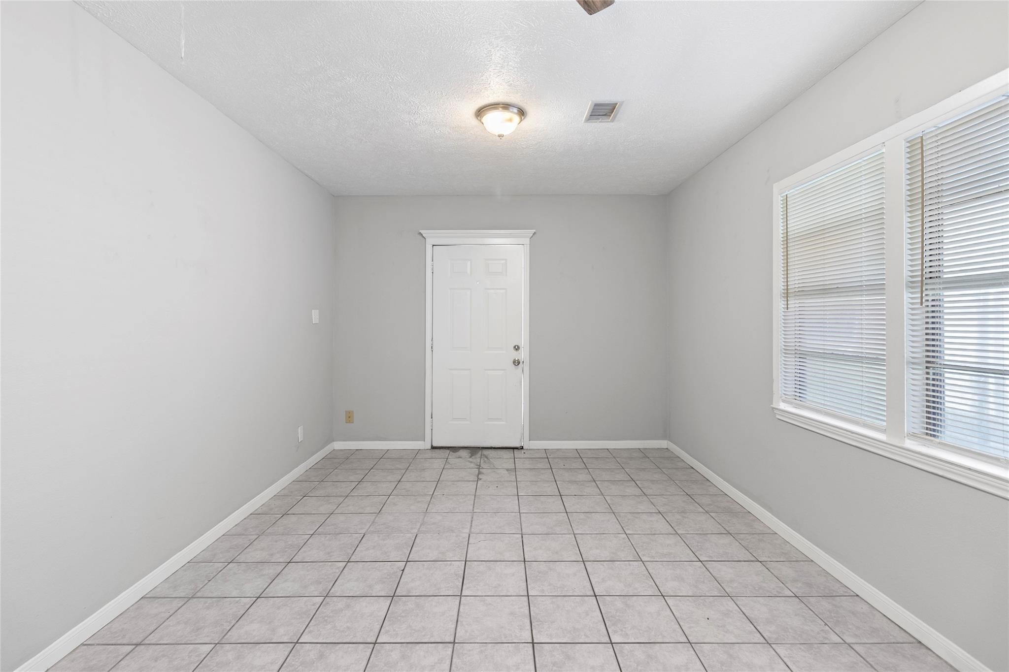 12109 22nd Street Santa Fe, TX 77510 - Photo 5 of 14 a view of an empty room with a window