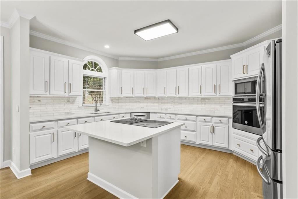3425 Kingsland Circle Berkeley Lake, GA 30096 - Photo 12 of 45 a kitchen with cabinets appliances a sink and a window