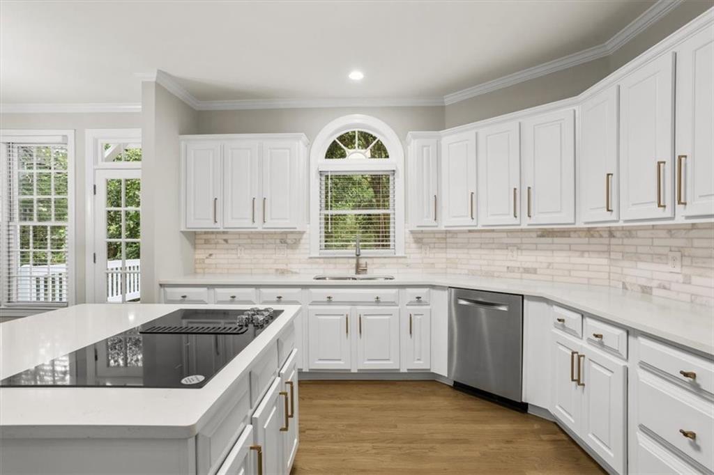 3425 Kingsland Circle Berkeley Lake, GA 30096 - Photo 13 of 45 a kitchen with granite countertop a sink white cabinets and window